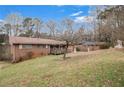 Back view of single-story home with a spacious yard, showcasing exterior and surroundings at 2807 Knollview Dr, Decatur, GA 30034