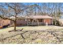 Quaint single-story home featuring a brick facade, front porch with ramp, and a well-maintained lawn at 2807 Knollview Dr, Decatur, GA 30034