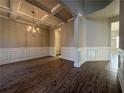 Elegant dining room showcasing hardwood floors, coffered ceilings, wainscotting, and a stylish chandelier at 3592 Hancock Vw, Decatur, GA 30034