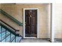 Exterior shot of the front door featuring a modern brown color scheme and secure entrance at 414 Ridge Creek Dr, Clarkston, GA 30021