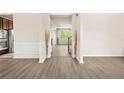 Inviting entryway featuring modern flooring, neutral walls, and decorative wainscoting at 15 Manas Ct, Covington, GA 30016