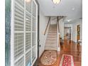 Welcoming foyer with hardwood floors and a staircase leading to the upper level at 2034 Reavis Blf, Conyers, GA 30012
