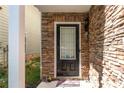 Inviting front entrance with stone facade, stylish door, and a welcoming mat at 2034 Reavis Blf, Conyers, GA 30012