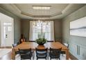 Dining room with a wooden table, stylish chairs, pendant lighting, and wainscoting at 2112 Ivey Chase Dr, Dacula, GA 30019