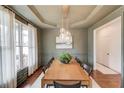 Dining room with hardwood floors, modern light fixture, and view of the front yard at 2112 Ivey Chase Dr, Dacula, GA 30019