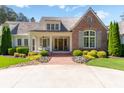 Inviting front porch with rocking chairs, brick walkway, and manicured landscaping adding to the curb appeal at 101 Morgan Ln, Canton, GA 30115