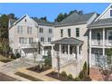 Beautiful brick townhome with covered porch and manicured landscaping showcasing its inviting curb appeal at 2035 Parkside Ln, Roswell, GA 30076