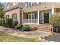 Charming front porch with white railing, brick accents, and a welcoming wreath on the front door at 2123 Indian Ivey Ln, Dacula, GA 30019