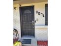Close-up of the front door featuring a security gate and prominent house number at 6071 Deerfield Ct, Morrow, GA 30260