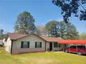 Inviting single-story home with brick accents, tidy landscaping and covered parking at 6071 Deerfield Ct, Morrow, GA 30260