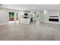 Open concept living room and kitchen with a fireplace and sliding doors to the outside at 3918 Artist Vw, Decatur, GA 30034