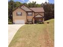 Welcoming two-story home with a well-kept lawn and a driveway leading to an attached garage at 504 Liverpool Dr, Mcdonough, GA 30252