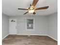 Bright living room featuring ceiling fan and updated wood-look floors throughout at 430 Argus Nw Cir, Atlanta, GA 30331