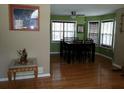 Bright dining room featuring hardwood floors, a modern ceiling fan, and large windows for ample natural light at 22 Briar Chase Ct, White, GA 30184