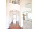 Bright foyer featuring hardwood floors, arched doorways, and wrought iron banister at 1143 Park Hollow Ne Ln, Lawrenceville, GA 30043