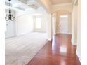 Spacious living room boasts hardwood floors, and stylish chandelier at 1143 Park Hollow Ne Ln, Lawrenceville, GA 30043