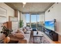 Cozy living room features a comfortable sectional sofa, large windows, and modern décor at 3324 Peachtree Ne Rd # 1104, Atlanta, GA 30326