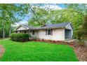 Inviting home exterior featuring a well-manicured lawn and charming curb appeal at 556 Auburn Rd, Auburn, GA 30011
