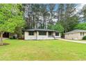 Beautifully renovated home featuring a well-manicured lawn and mature trees at 117 Hillsdale Dr, Atlanta, GA 30315
