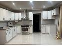 Modern kitchen features stainless steel appliances, white cabinets, and recessed lighting at 33 Stratford Nw Dr, Atlanta, GA 30311