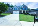 Beautiful two-story brick home with a manicured lawn, covered porch, and a long driveway at 545 Eldridge Dr, Suwanee, GA 30024