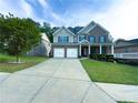 Attractive two-story brick home featuring a well-kept lawn, covered porch, and spacious driveway at 545 Eldridge Dr, Suwanee, GA 30024