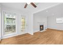 Living room featuring hardwood floors, a fireplace, and a door to the outdoor space at 901 Gettysburg Pl, Atlanta, GA 30350