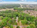 Aerial view of property nestled among lush greenery, showcasing its desirable location at 1675 Commonwealth Trl, Cumming, GA 30041