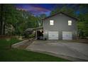 Charming two-story home with a gray shingle exterior and a two-car garage and a nice lawn at 1675 Commonwealth Trl, Cumming, GA 30041