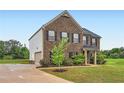 Charming brick home features an attached garage and a lovely front yard at 229 Prescott St, Locust Grove, GA 30248