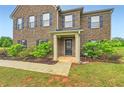 Inviting front entrance of home with a brick facade and trimmed greenery at 229 Prescott St, Locust Grove, GA 30248