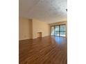 Spacious living room with hardwood floors, fireplace, and sliding glass doors to balcony at 3575 Oakvale Road # 303, Decatur, GA 30034