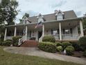 Charming single Gathering home featuring a wide front porch and well manicured front yard and inviting curb appeal at 3592 Galdway Dr, Snellville, GA 30039