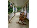 Inviting front porch with rocking chairs and comfortable seating, perfect for enjoying the outdoors at 3592 Galdway Dr, Snellville, GA 30039