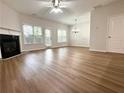 Open-concept living room with wood floors, a fireplace, and access to the patio at 5872 Oakbrook Lake Ct, Norcross, GA 30093