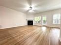 Spacious living room with a fireplace, wood floors, and lots of natural light at 5872 Oakbrook Lake Ct, Norcross, GA 30093