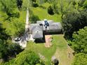 Overhead view of a home with mature trees, a garden area, and circular driveway at 11433 Panhandle Rd, Hampton, GA 30228