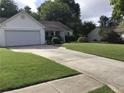 Well-manicured lawn and driveway leading to a two-car garage at 431 Crested View Dr, Loganville, GA 30052