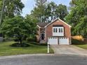 Inviting brick home boasts a well-maintained lawn and attached two-car garage at 504 Radford Ct, Woodstock, GA 30188