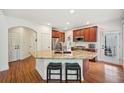 Bright kitchen boasts granite countertops, stainless steel appliances, and hardwood floors throughout at 75 Vinings Lake Sw Dr, Mableton, GA 30126