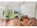 Inviting living room with a fireplace, high ceilings, hardwood floors, and large windows at 75 Vinings Lake Sw Dr, Mableton, GA 30126
