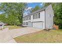 Two-story white brick house with attached garage and black shutters, surrounded by a well-maintained lawn at 285 Camden Park Dr, Lawrenceville, GA 30046