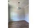 Cozy dining room features hardwood floors, neutral walls, modern lighting, and elegant trim at 3036 Zodiac Ct, Lawrenceville, GA 30044