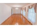 Spacious living room with hardwood floors, natural light, and a chandelier at 3560 Emily Way, Atlanta, GA 30349