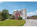 Two-story home with brick and siding, plus a long driveway leading to a garage at 3715 Frankie Wade Ln, Loganville, GA 30052