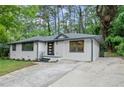 Ranch style home showcasing updated landscaping and a concrete driveway at 140 Larose Se Cir, Marietta, GA 30060