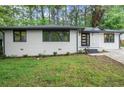Newly renovated home with white painted brick, updated windows and refreshed landscaping at 140 Larose Se Cir, Marietta, GA 30060