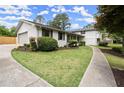 Beautifully landscaped exterior with a well-maintained lawn and concrete walkway at 1863 Trumbull Dr, Atlanta, GA 30338