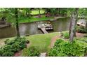 Beautiful waterfront property with boat dock and meticulously maintained landscaping at 520 Flying Scot Way, Alpharetta, GA 30005
