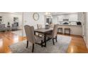 Dining area and open concept kitchen with hardwood floors and comfortable seating at 2360 Elon Way, Decatur, GA 30033